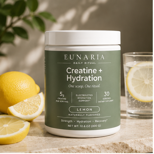 Eunaria Creatine + Hydration jar with fresh lemons and glass of water on kitchen counter